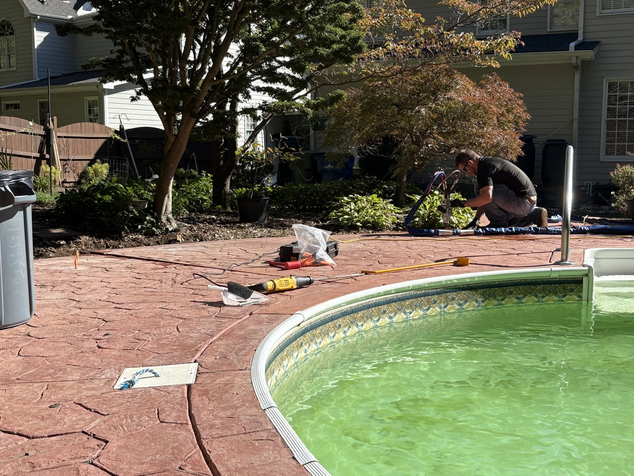 Crew working on pool deck lifting project