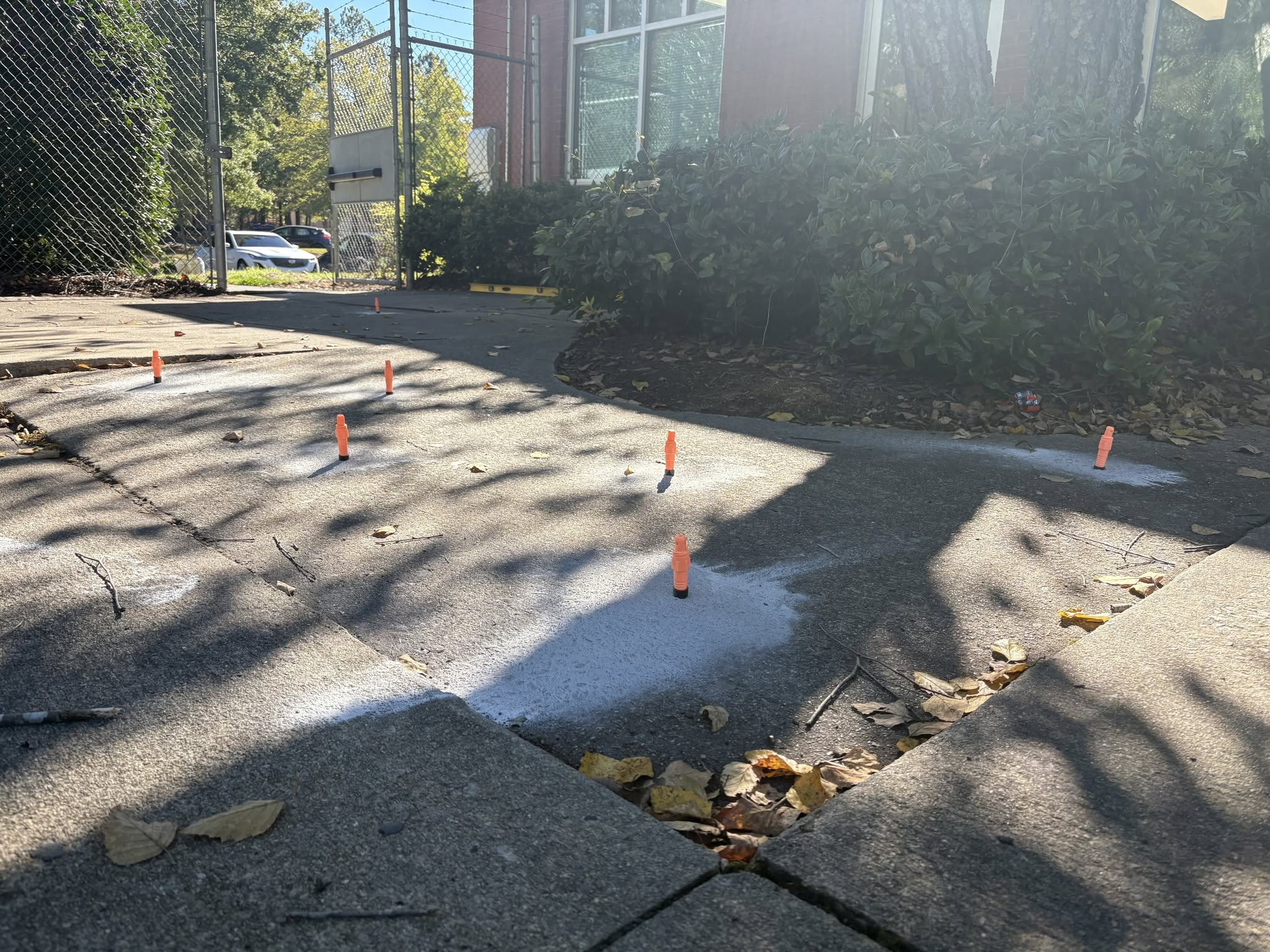 Sidewalk after foam injection ports installed and concrete leveled